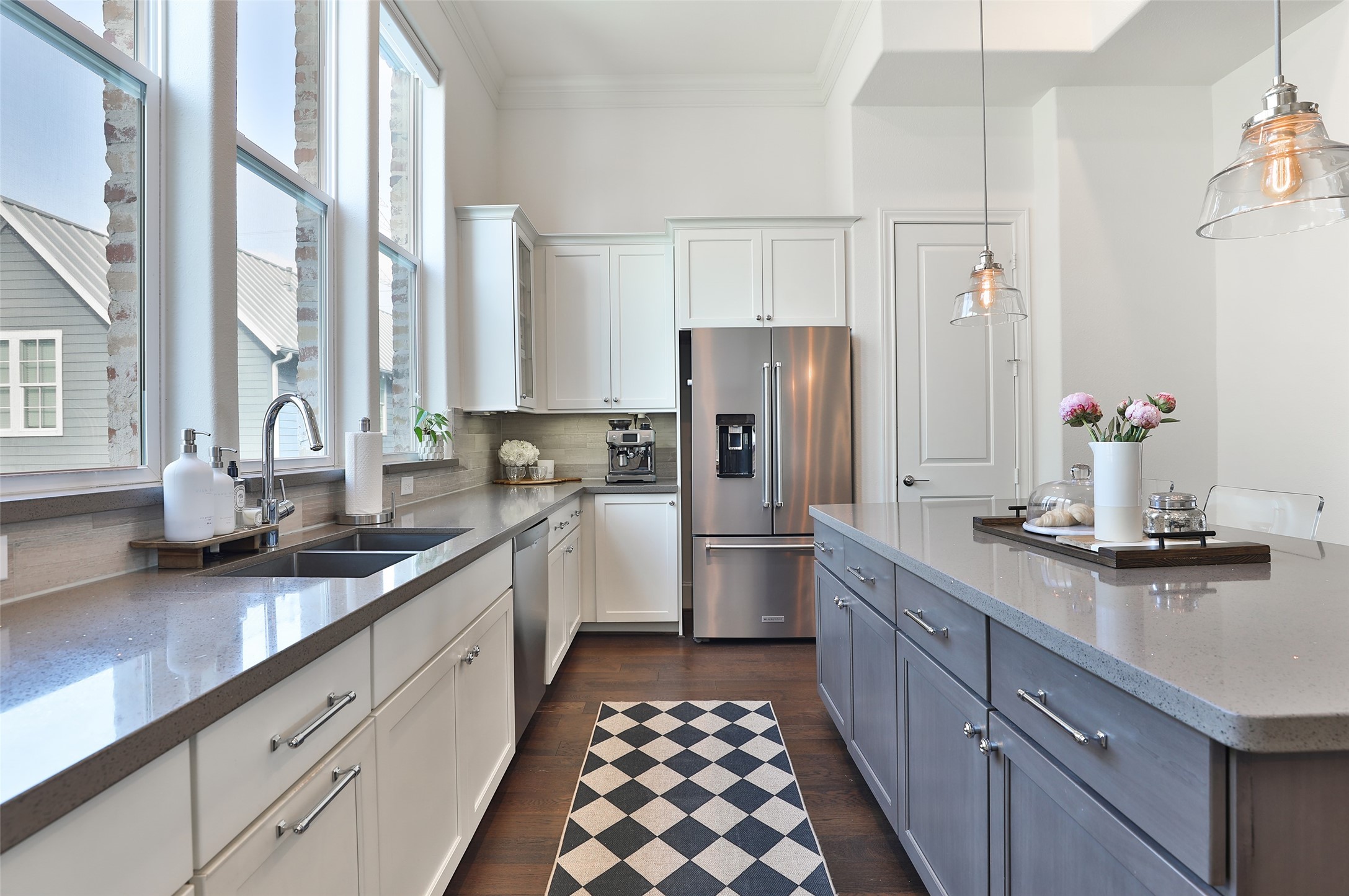 2303 Kolbe Run Lane Houston, TX 77080 - Photo 14 of 35 Kitchen windows outfitted with electric roller shades to block the summer heat. The kitchen boasts ample cabinet space, perfect for all your cooking gadgets, creating an inviting hub for culinary creativity.