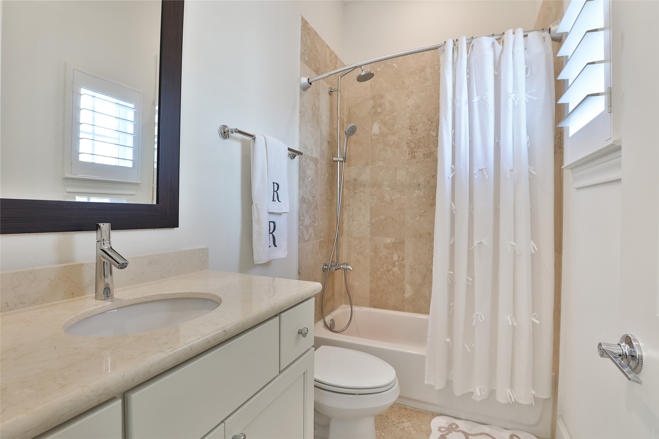 2303 Kolbe Run Lane Houston, TX 77080 - Photo 28 of 35 Ensuite secondary bath emits elegance and class with neutral tiles and fixtures.