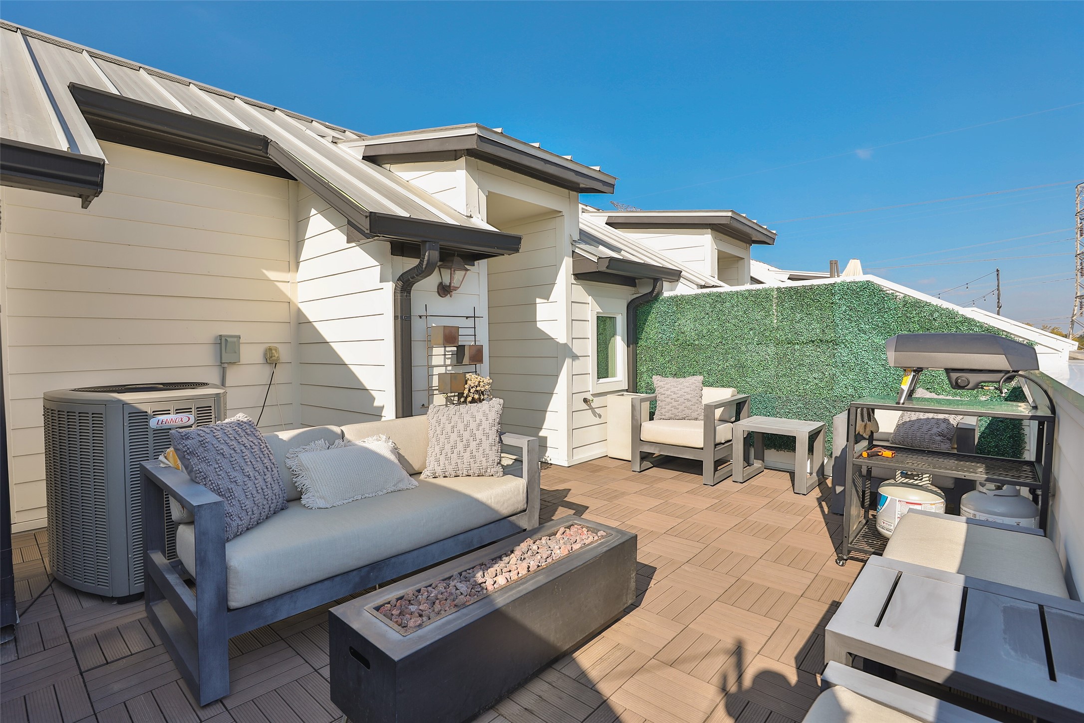2303 Kolbe Run Lane Houston, TX 77080 - Photo 29 of 35 This rooftop terrace features modern outdoor seating, and a privacy fence with greenery. Ideal for entertaining or relaxing, it offers a stylish, comfortable space with views.