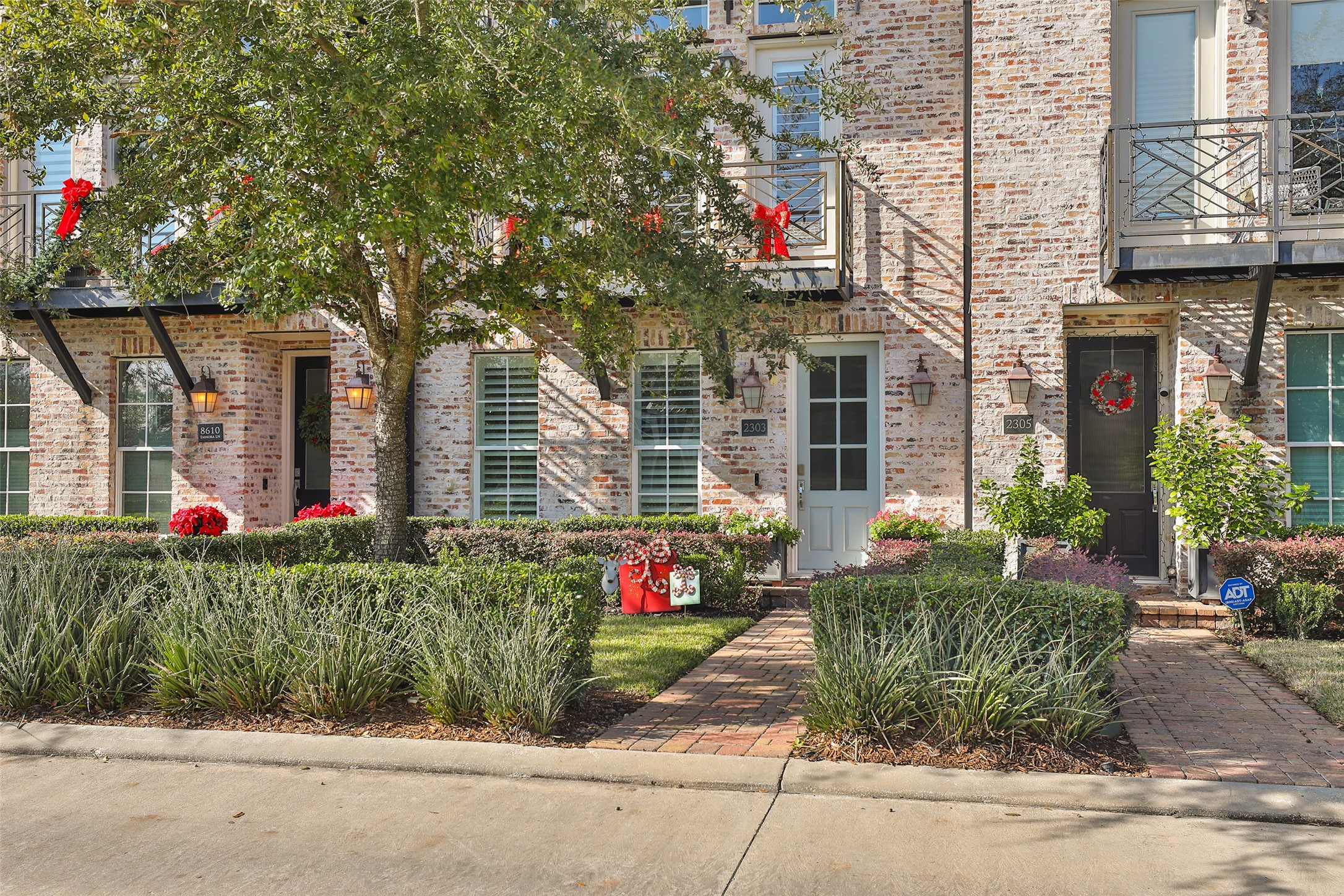 2303 Kolbe Run Lane Houston, TX 77080 - Photo 4 of 35 The well-maintained landscaping includes lush greenery and a brick pathway, creating an inviting curb appeal.