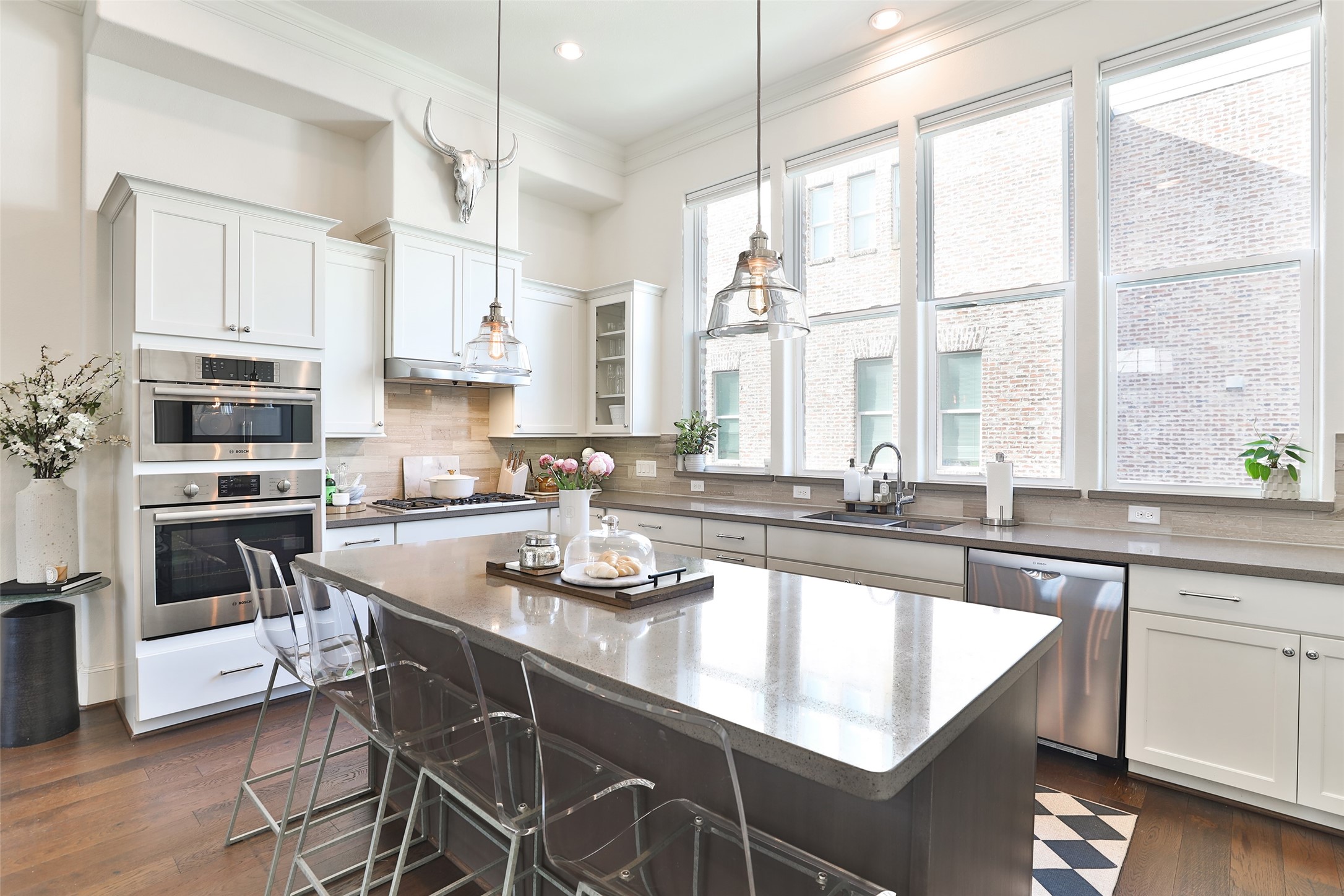 2303 Kolbe Run Lane Houston, TX 77080 - Photo 10 of 35 This kitchen is a chef's delight, featuring elegant shaker cabinets, sleek quartz countertops, energy-efficient LED windows with electric roller shades, and top-of-the-line Bosch stainless appliances.