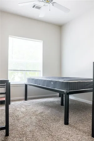 a spacious bathroom with a toilet sink and mirror