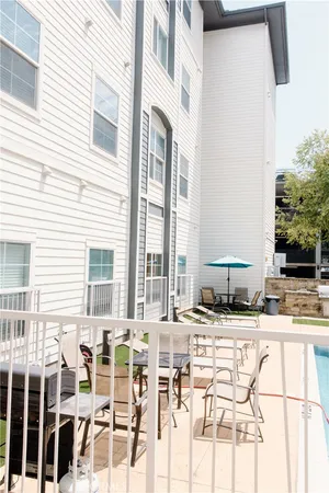 a swimming pool with outdoor seating and yard