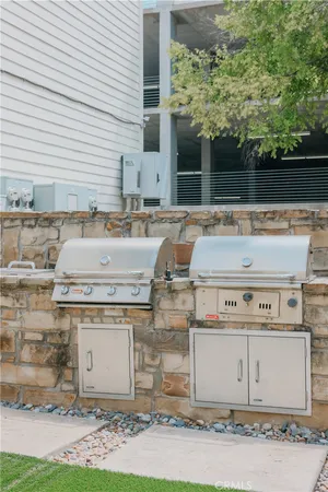 a view of a small house with a yard and sitting area