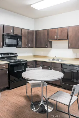 a kitchen with a stove a sink and a refrigerator
