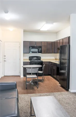 a living room with a couch and a refrigerator