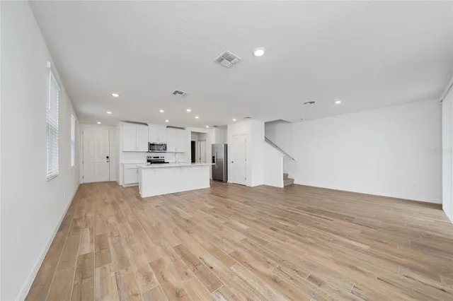 a view of kitchen with kitchen island sink and refrigerator
