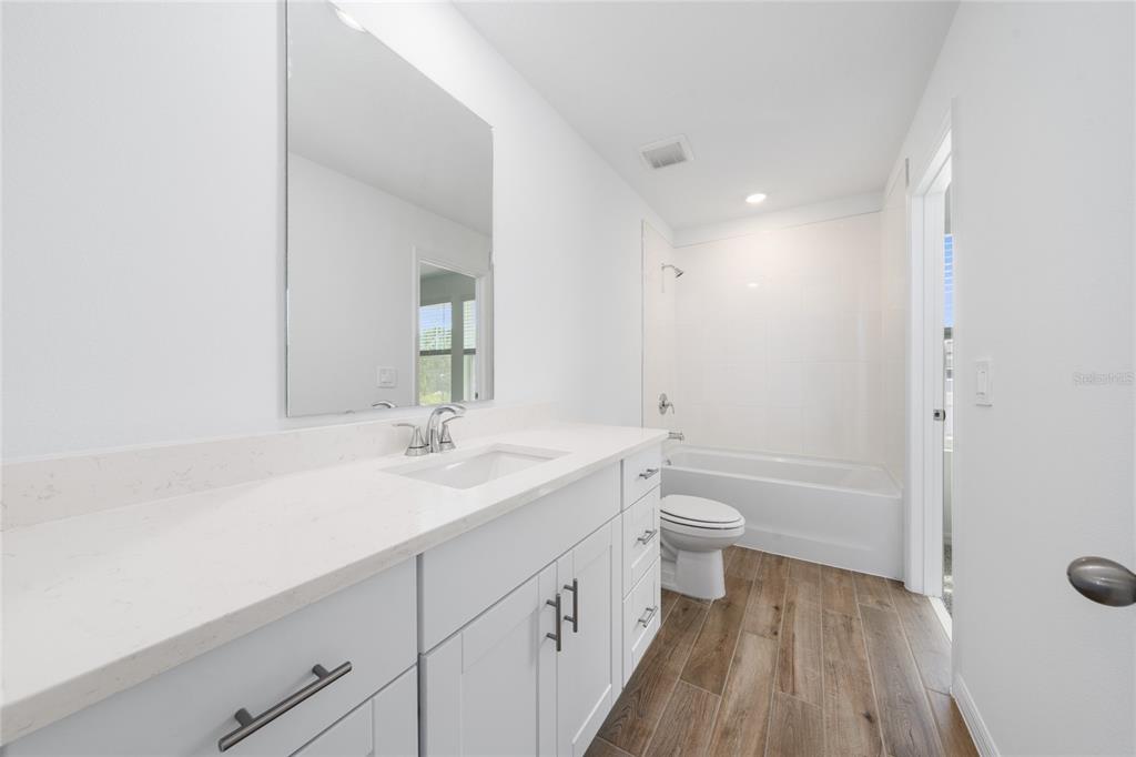 4272 Ranch House Road St. Cloud, FL 34772 - Photo 22 of 29 a bathroom with a double vanity sink toilet and shower