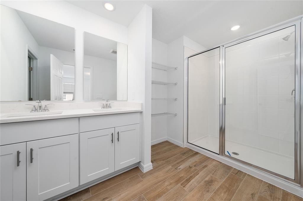 4272 Ranch House Road St. Cloud, FL 34772 - Photo 25 of 29 a bathroom with a double vanity sink and mirror