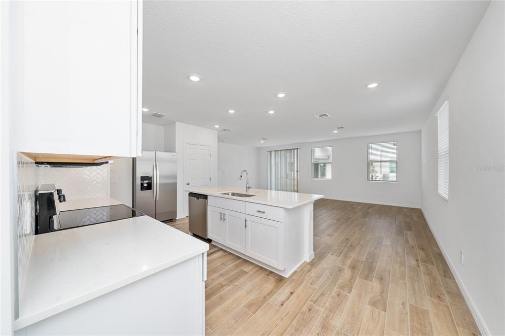 4272 Ranch House Road St. Cloud, FL 34772 - Photo 8 of 29 a kitchen with cabinets and wooden floor