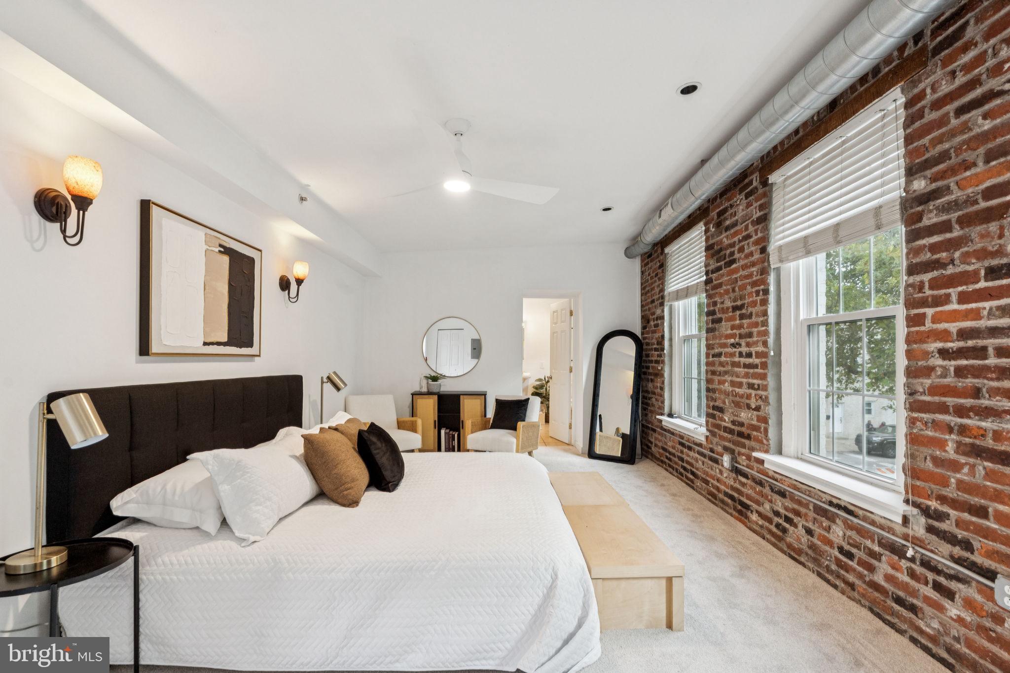 a bedroom with a large bed and a large window