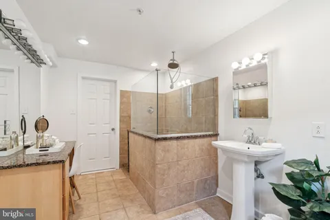 a bathroom with a sink a mirror and a shower