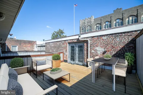 a view of a patio with table and chairs and potted plants
