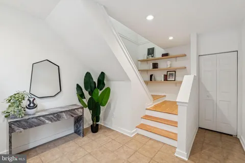 a living room with furniture and potted plant