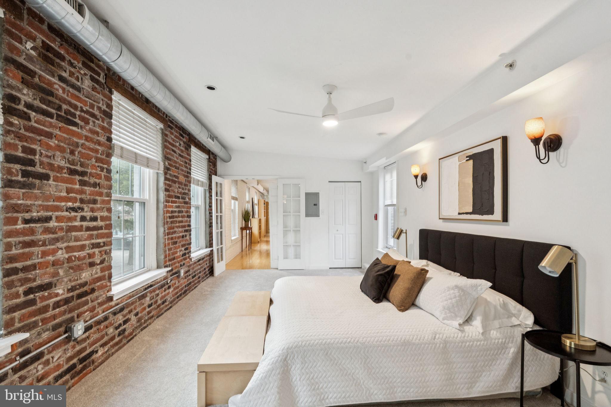 1246 East Montgomery Avenue, Unit 5 Philadelphia, PA 19125 - Photo 10 of 18 a bedroom with a bed and a large window