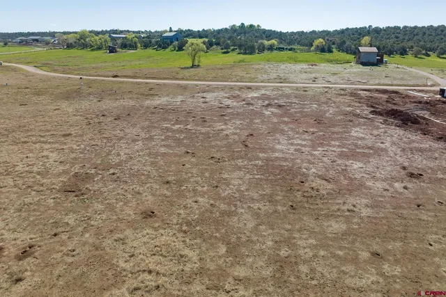 a view of a field with a building