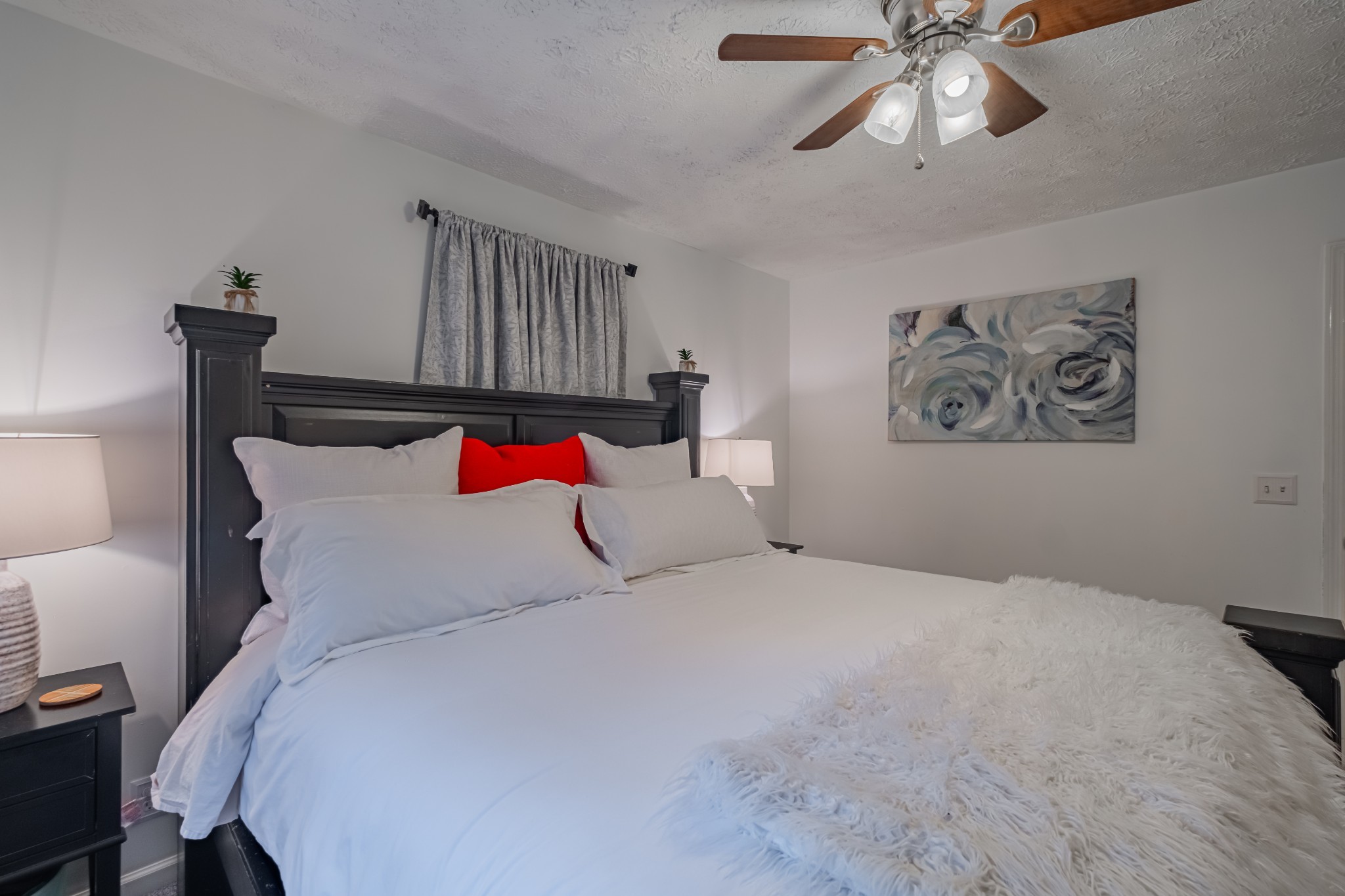 1450 Pleasant Hill Road McMinnville, TN 37110 - Photo 23 of 68 a bedroom with a bed and a chandelier