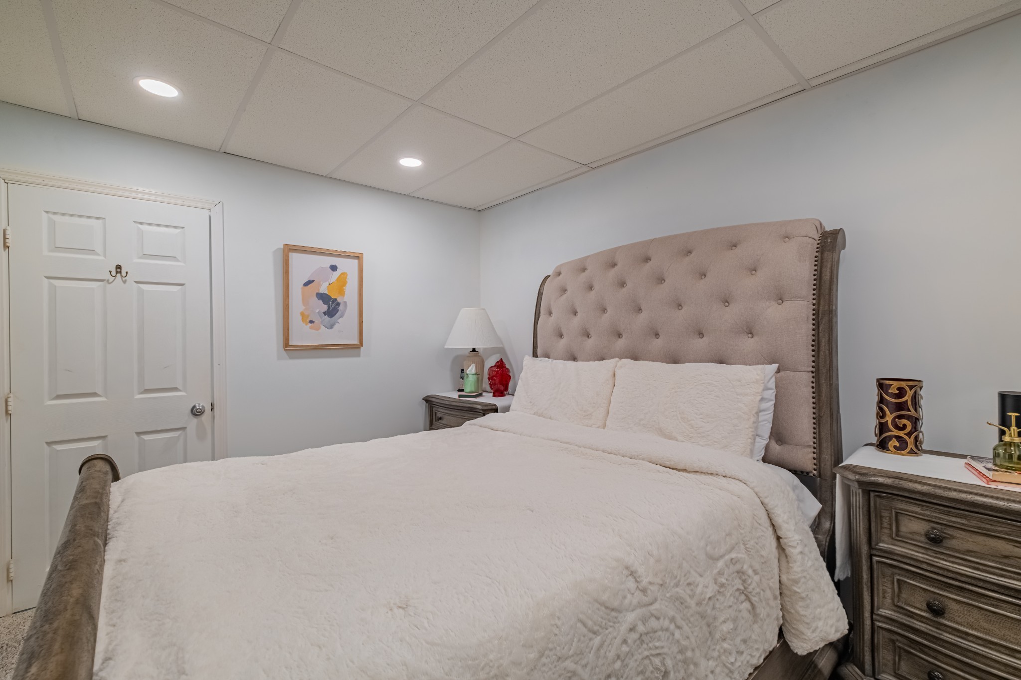 1450 Pleasant Hill Road McMinnville, TN 37110 - Photo 33 of 68 a bedroom with a large bed and a chandelier