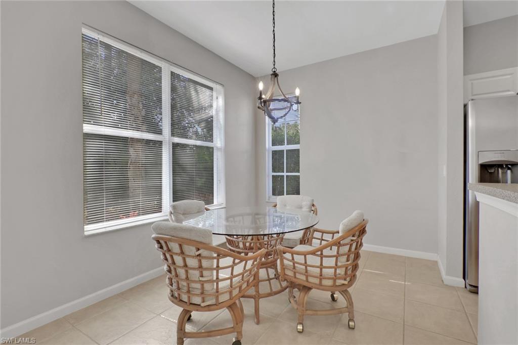 7844 Clemson Street, Unit 102 Naples, FL 34104 - Photo 12 of 31 a view of a dining room with furniture window and outside view