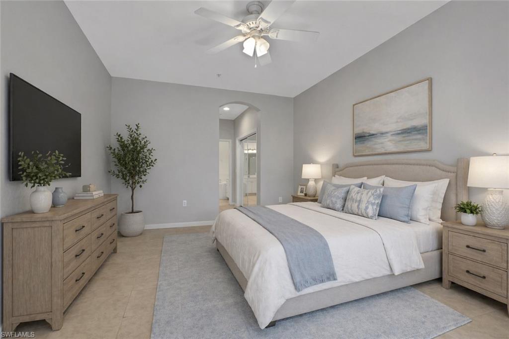 7844 Clemson Street, Unit 102 Naples, FL 34104 - Photo 13 of 31 a bedroom with a bed and a flat screen tv