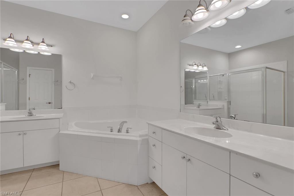 7844 Clemson Street, Unit 102 Naples, FL 34104 - Photo 16 of 31 a bathroom with a sink vanity and mirror