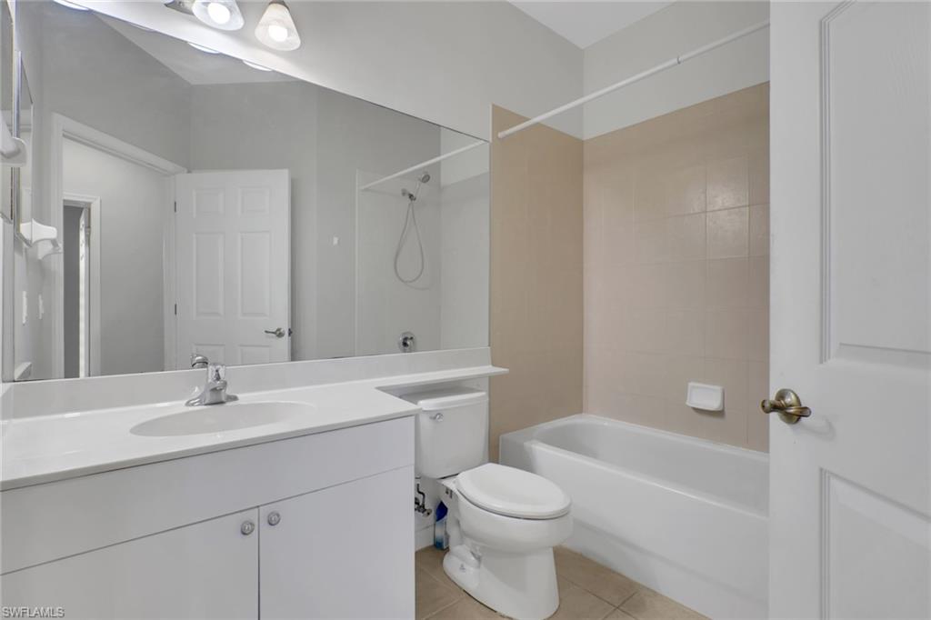7844 Clemson Street, Unit 102 Naples, FL 34104 - Photo 20 of 31 a bathroom with a sink a toilet and shower
