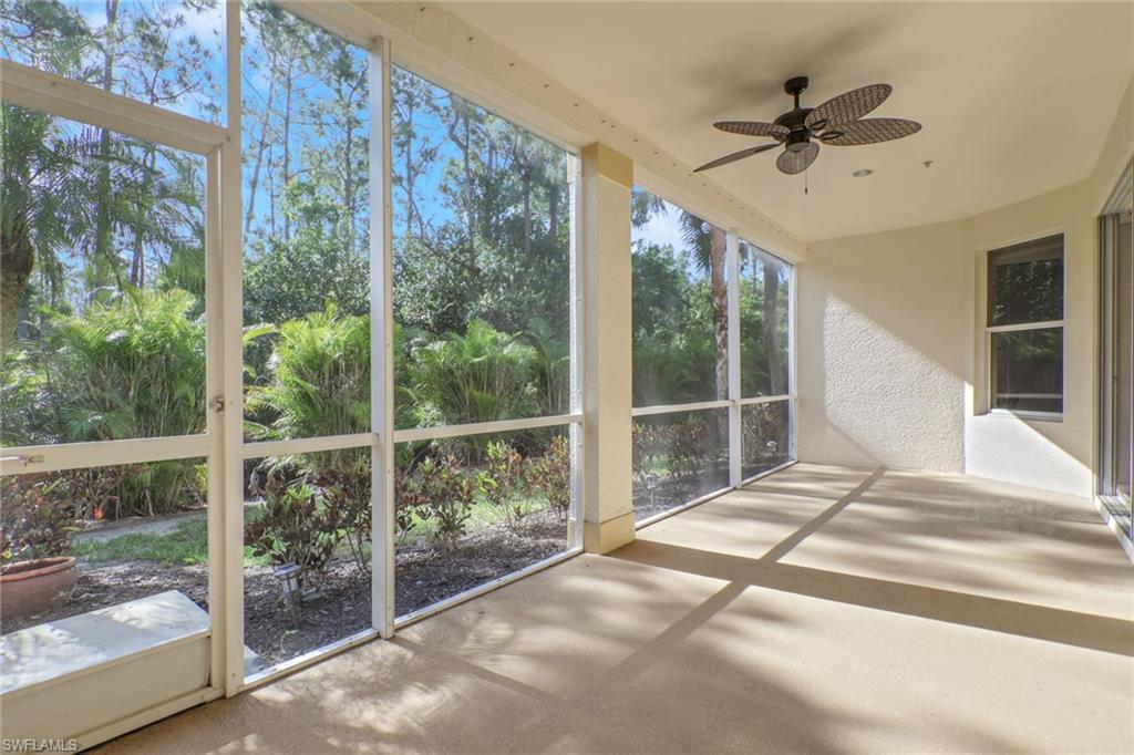 7844 Clemson Street, Unit 102 Naples, FL 34104 - Photo 25 of 31 a bed sitting in a bedroom next to a window