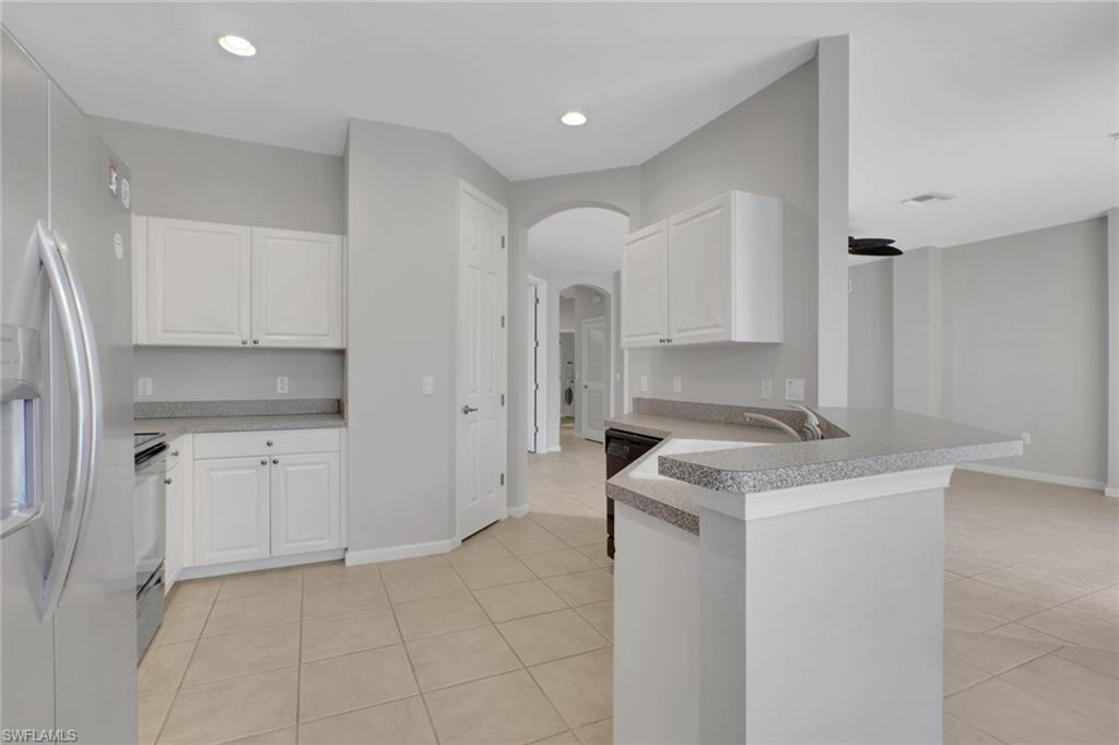7844 Clemson Street, Unit 102 Naples, FL 34104 - Photo 8 of 31 a kitchen with a sink stove and cabinets