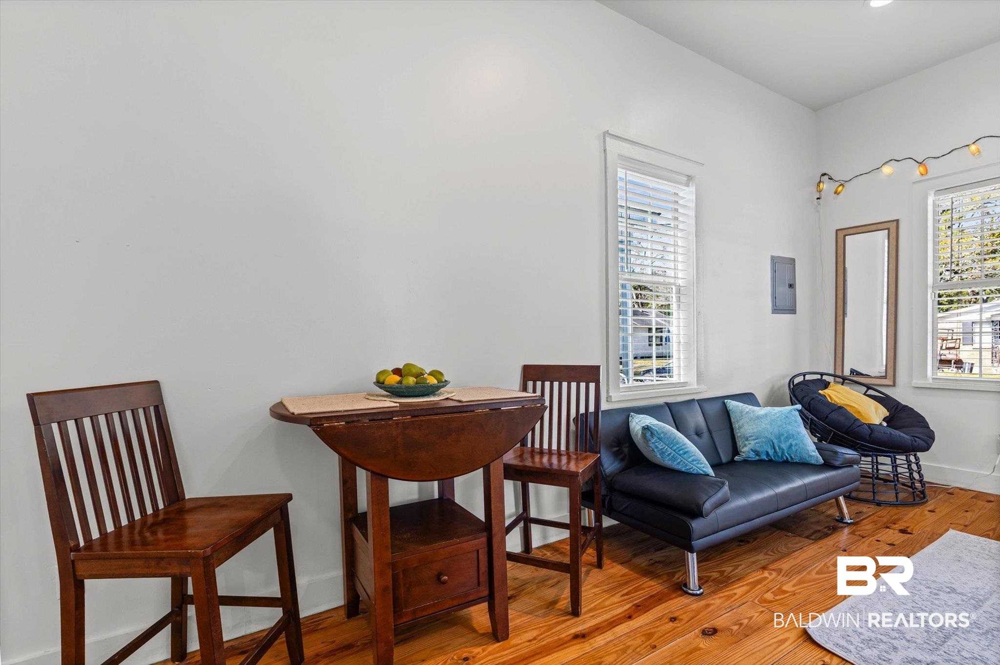 951 Montgomery Street Mobile, AL 36604 - Photo 9 of 22 Interior space featuring light-toned walls, wood-finish flooring, multiple windows with blinds, and a built-in electrical panel