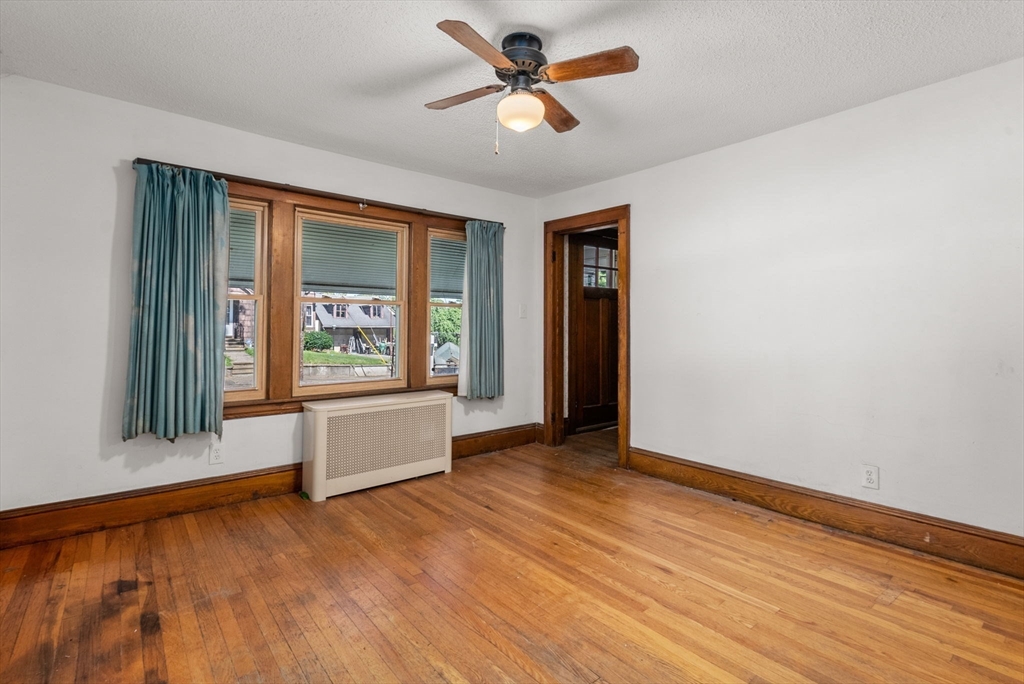 41 Nevada Street Springfield, MA 01107 - Photo 11 of 33 wooden floor in an empty room with a window