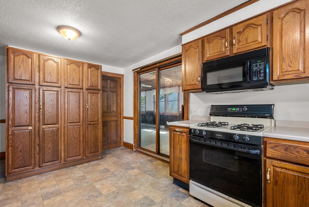 41 Nevada Street Springfield, MA 01107 - Photo 6 of 33 a kitchen with stainless steel appliances granite countertop a stove microwave and refrigerator