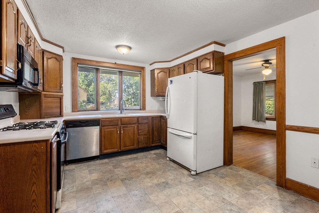 41 Nevada Street Springfield, MA 01107 - Photo 8 of 33 a kitchen with a refrigerator and a stove