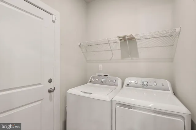 a view of storage and utility room with washer and dryer