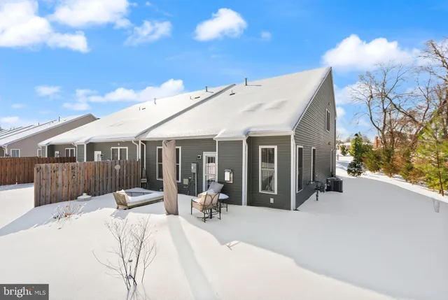a view of a white house with a patio