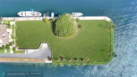an aerial view of a house with a lake