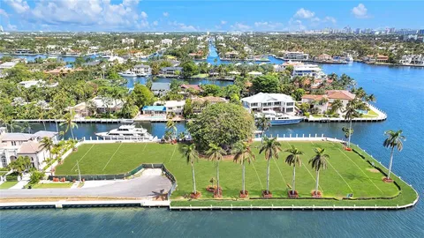 an aerial view of a house with a lake