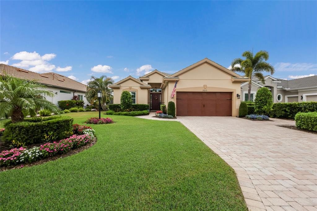 5011 Tobermory Way Bradenton, FL 34211 - Photo 2 of 77 a front view of a house with a yard and garage