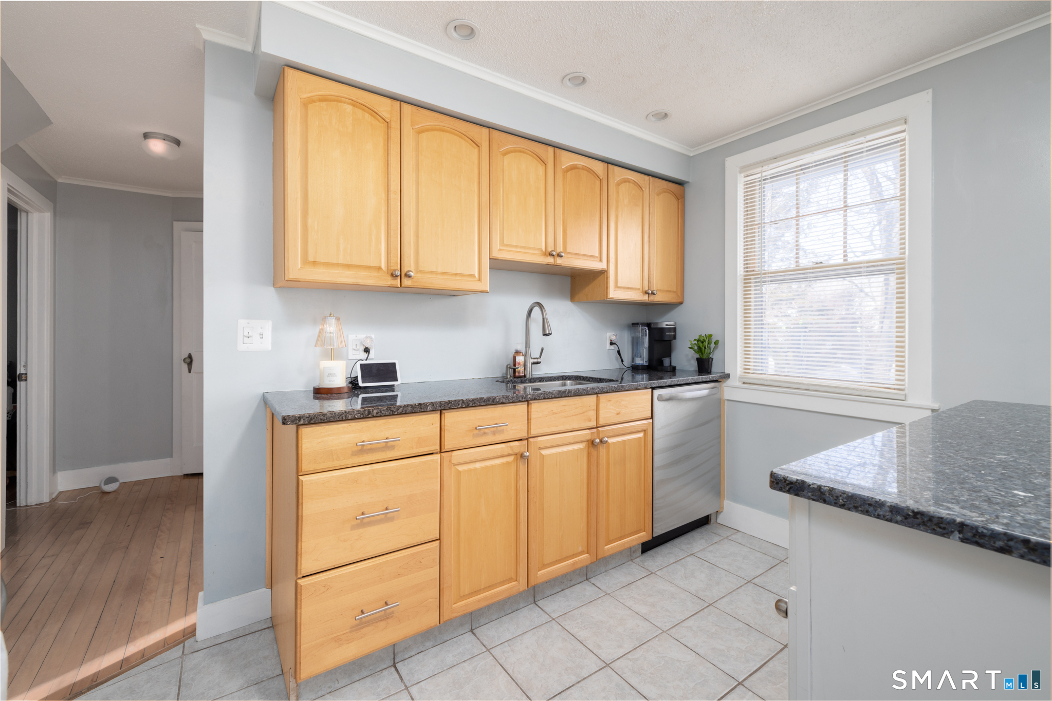 51 Rockridge Road Waterbury, CT 06705 - Photo 11 of 18 a kitchen with granite countertop white cabinets sink and window