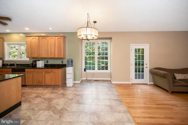 a view of kitchen with granite countertop window and a sink