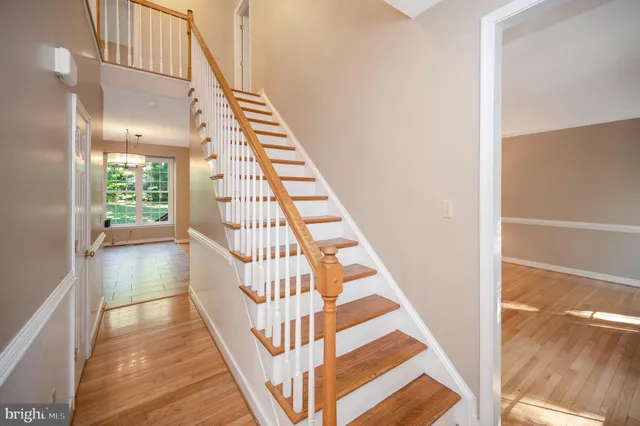 a view of a hallway with wooden floor and entryway