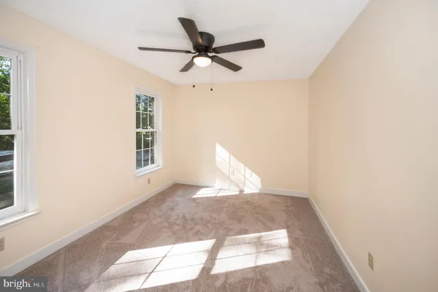 a view of a livingroom with a ceiling fan and window
