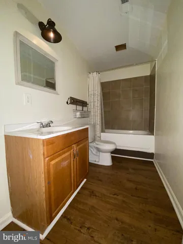 a bathroom with a sink a toilet and mirror
