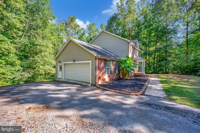 a view of a house with garden and yard