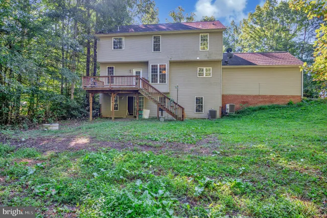 a view of a house with a yard and sitting area