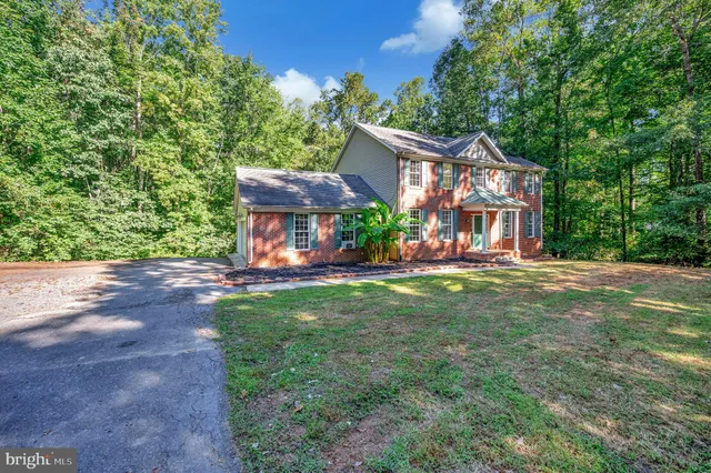 a view of a house with a yard porch and sitting area