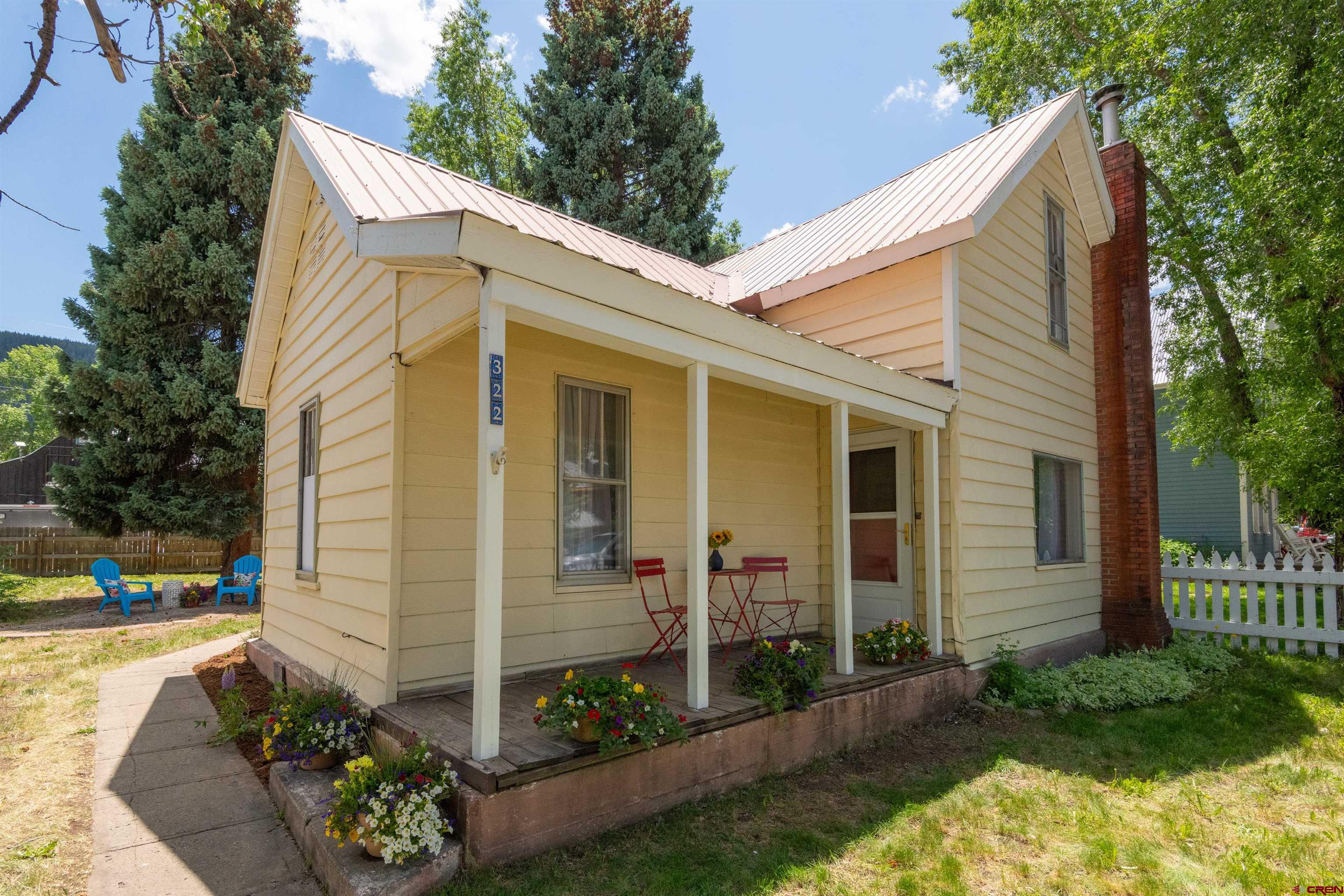 322 Maroon Avenue Crested Butte, CO 81224 - Photo 1 of 24 a view of a house with yard and a garden