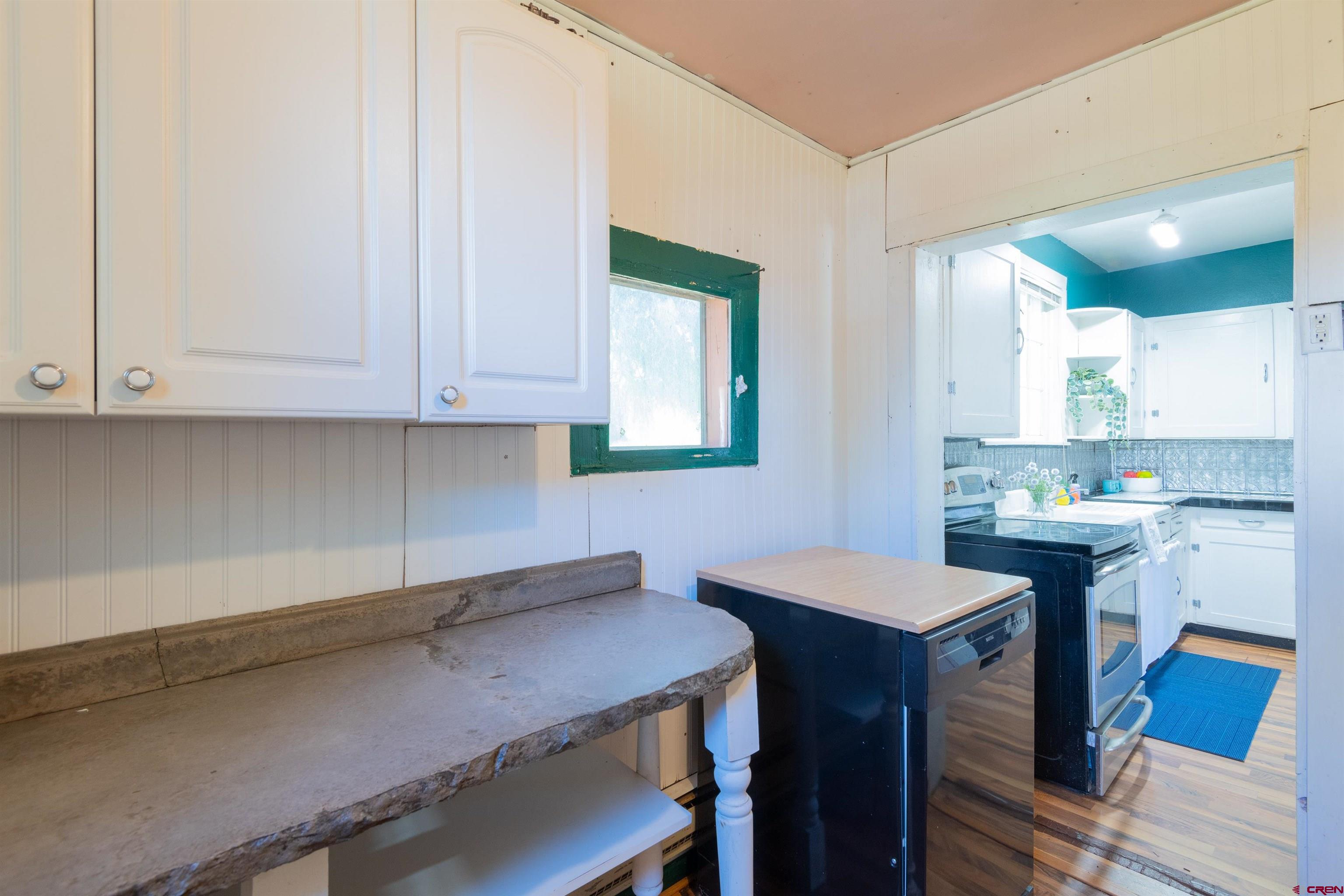 322 Maroon Avenue Crested Butte, CO 81224 - Photo 15 of 24 a kitchen with a sink cabinets and wooden floor