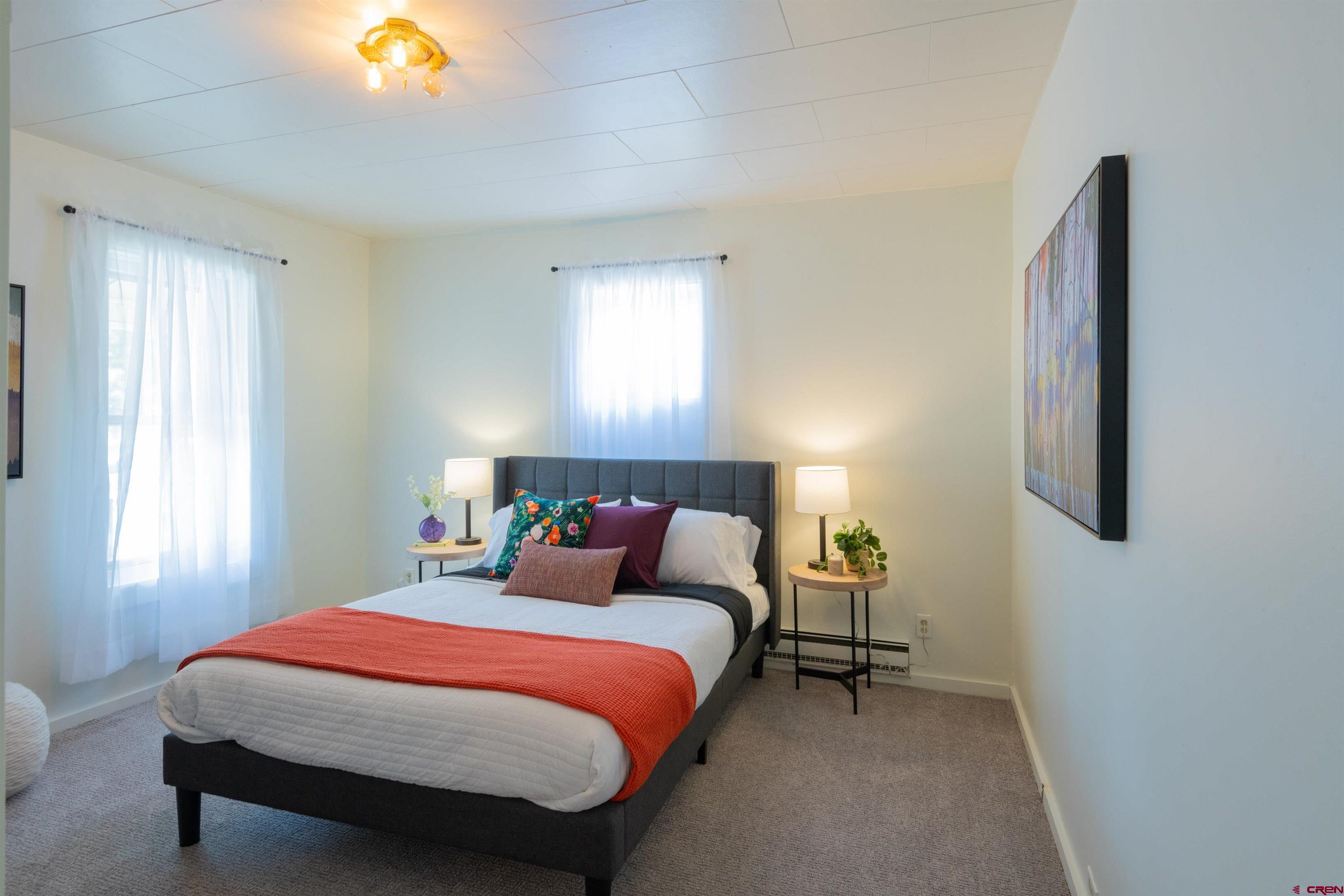 322 Maroon Avenue Crested Butte, CO 81224 - Photo 17 of 24 a bedroom with a bed and lamps