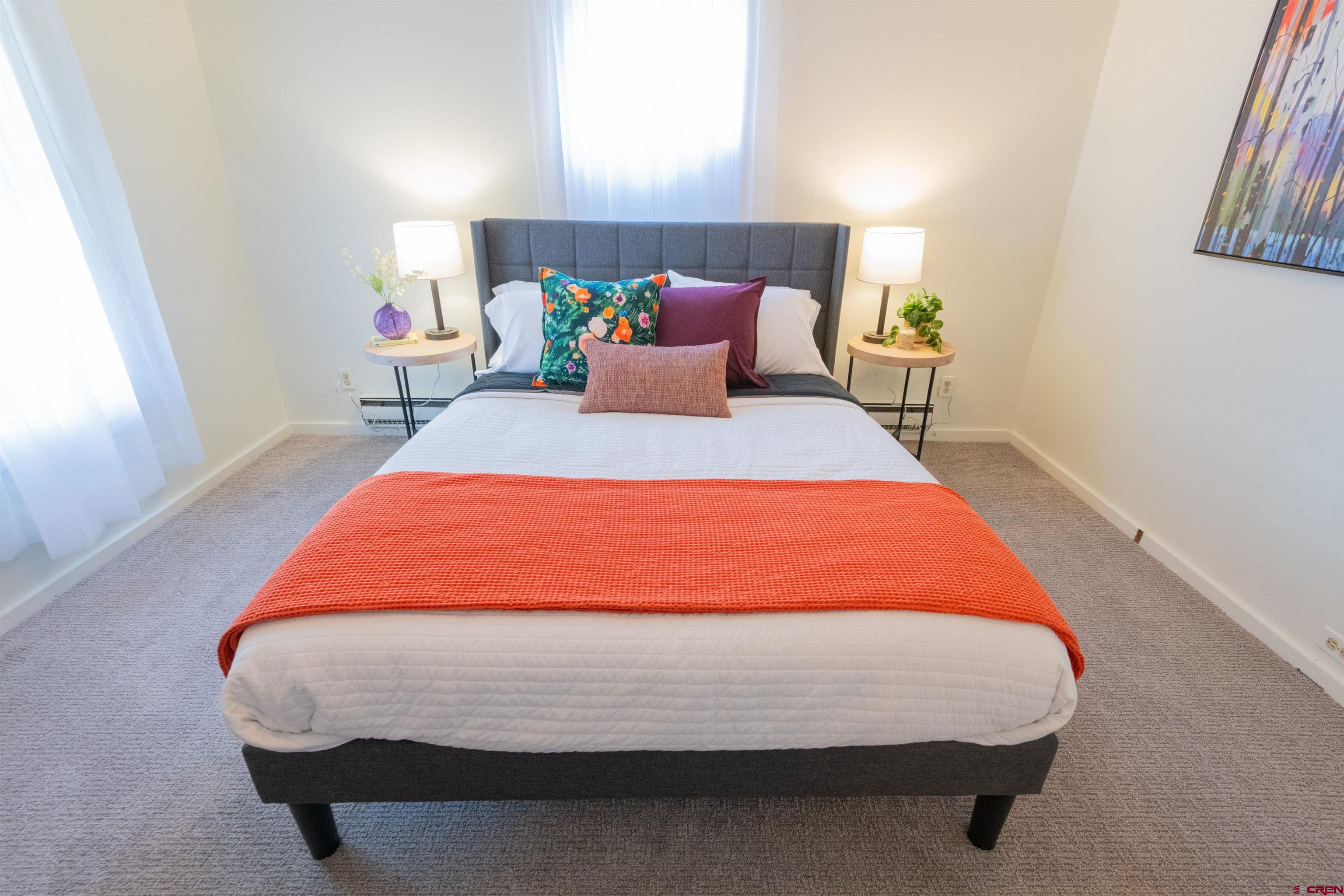 322 Maroon Avenue Crested Butte, CO 81224 - Photo 18 of 24 a bed sitting in a bedroom next to a window