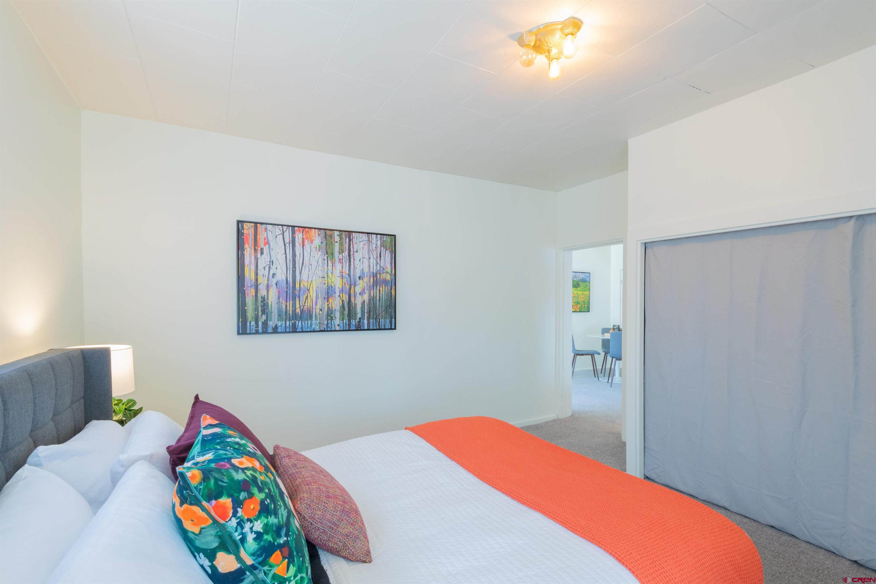 322 Maroon Avenue Crested Butte, CO 81224 - Photo 19 of 24 a bedroom with a bed and a painting on the wall